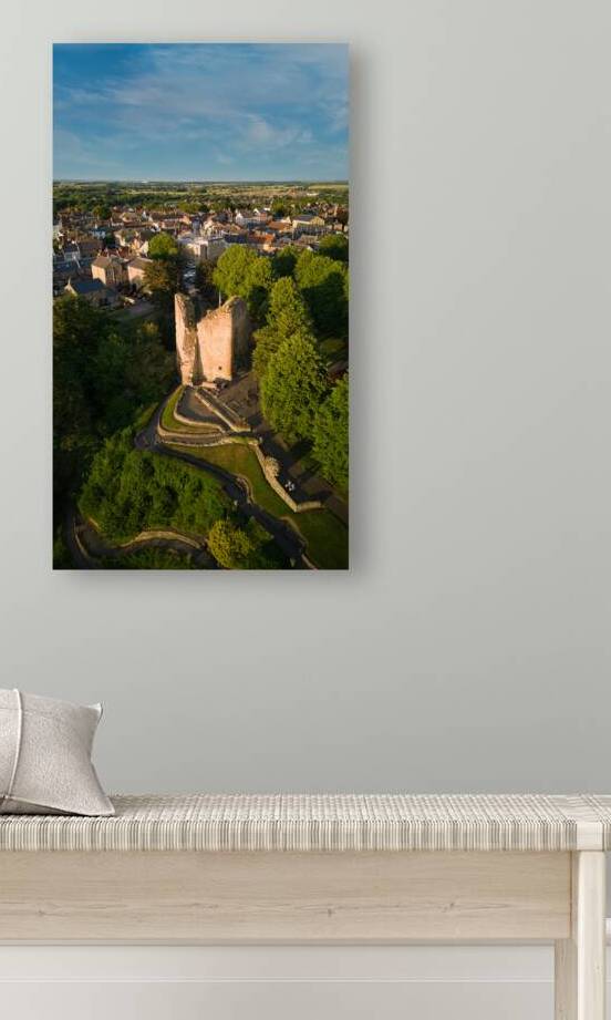 Aerial view of a quaint town with historic tower surrounded by greenery under a clear blue sky Aerial view of a historic town with an ancient tower surrounded by lush green trees under a clear blue sky in Knaresborough North Yorkshire. by Vasile Jechiu