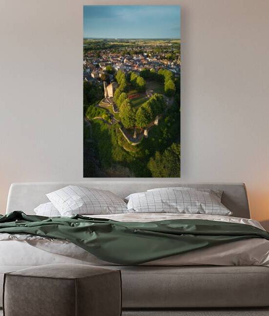 Aerial view of a quaint town with historic windmill surrounded by lush greenery at sunset Aerial view of a historic town with an ancient tower surrounded by lush green trees under a clear blue sky in Knaresborough North Yorkshire. by Vasile Jechiu